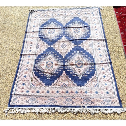 966 - A red ground carpet, 254 cm x 166 cm, and a blue ground rug, 193 cm x 132 cm (2)