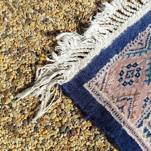 966 - A red ground carpet, 254 cm x 166 cm, and a blue ground rug, 193 cm x 132 cm (2)
