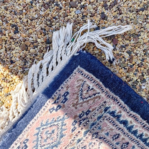 966 - A red ground carpet, 254 cm x 166 cm, and a blue ground rug, 193 cm x 132 cm (2)