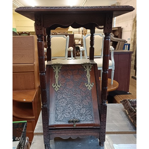 978 - An aesthetic period walnut coal purdonium, carved foliate forms, 60 cm high x 34 cm wide
