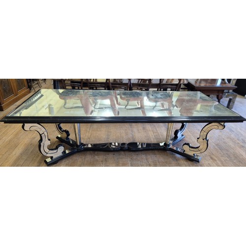 1004 - A late 20th century Italian mirrored and ebonised dining table, with scrolled supports, the top 240 ... 