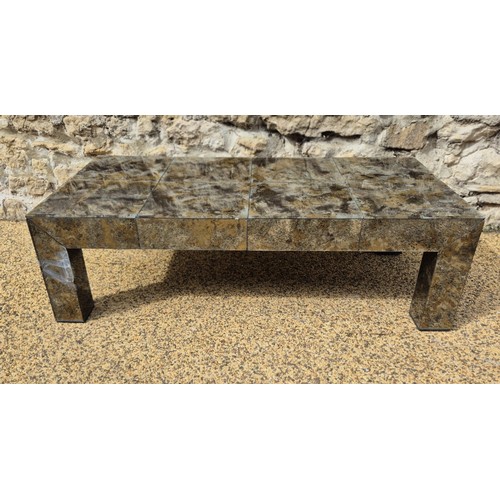 991 - A glass veneered coffee table, 25 cm high, the top 124 x 64 cm, some losses and cracks