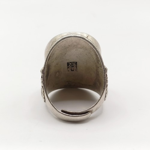 A Chinese silver coloured metal ring, with multi coloured stones, and a ...