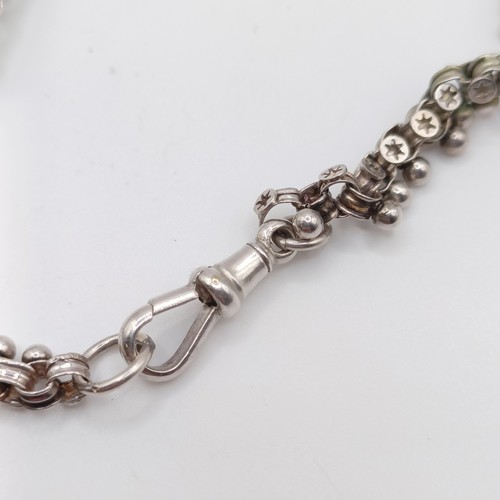 666 - An oval silver locket, decorated ferns and foliage, on a chain