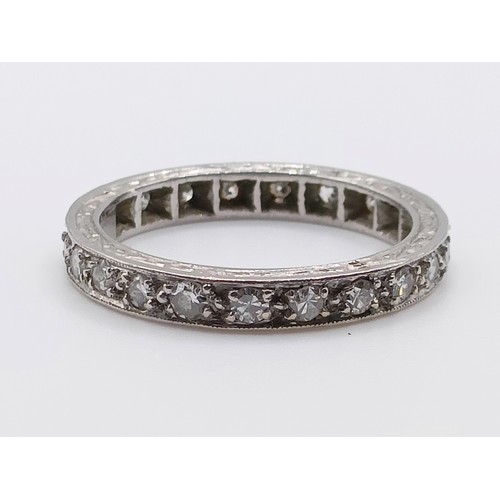 679 - A yellow coloured metal and diamond eternity ring, ring size J