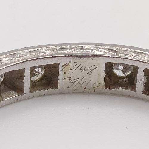 679 - A yellow coloured metal and diamond eternity ring, ring size J