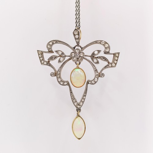 688 - An early 20th century opal and diamond pendant, on a later silver chain