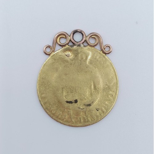 692 - A George III guinea, with a later mount, very worn, 7.9 g