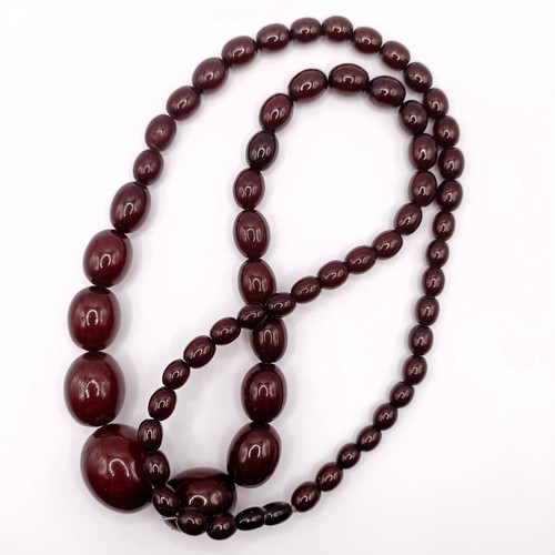 716 - An amber bead necklace, 62.4 g