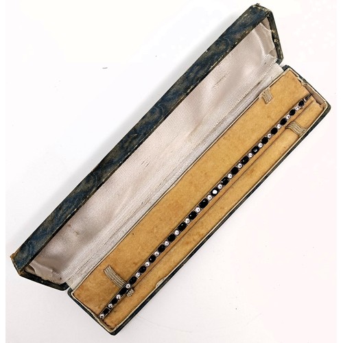 717 - A sapphire and white stone tennis bracelet, in a vintage jewellery box