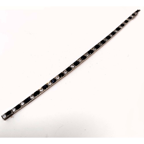 717 - A sapphire and white stone tennis bracelet, in a vintage jewellery box