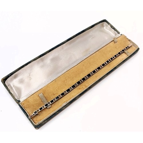 717 - A sapphire and white stone tennis bracelet, in a vintage jewellery box