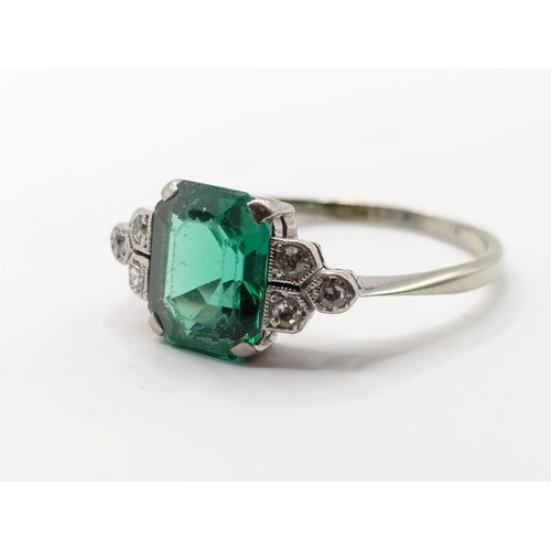 699 - An Art Deco 18ct gold, platinum, synthetic emerald and diamond ring, ring size O