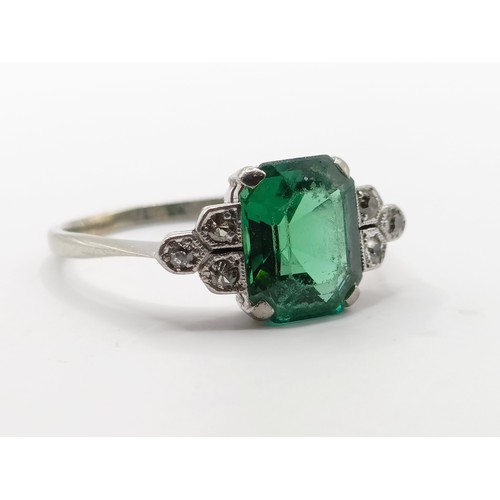 699 - An Art Deco 18ct gold, platinum, synthetic emerald and diamond ring, ring size O