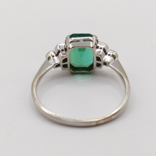 699 - An Art Deco 18ct gold, platinum, synthetic emerald and diamond ring, ring size O