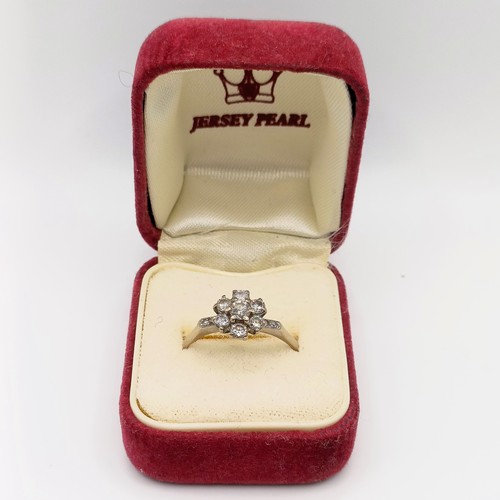 696 - A 18ct white gold and diamond flowerhead ring, ring size O