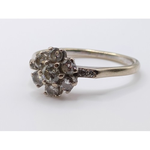 696 - A 18ct white gold and diamond flowerhead ring, ring size O