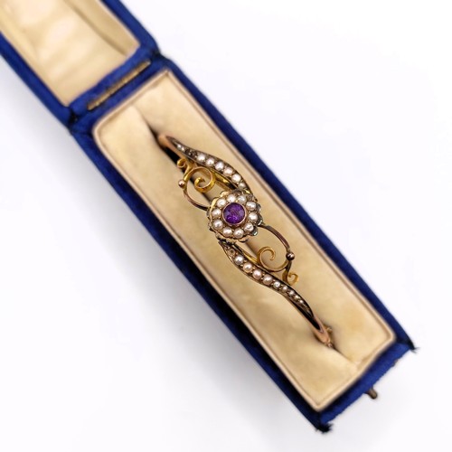 697 - A 9ct gold, amethyst and seed pearl bangle, 7.2 g all in, 7 cm wide, boxed