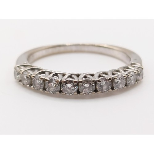 664 - An 18ct white gold and diamond half eternity ring, ring size K