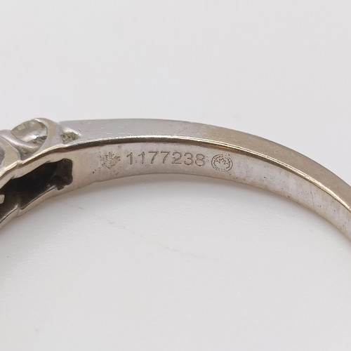 664 - An 18ct white gold and diamond half eternity ring, ring size K