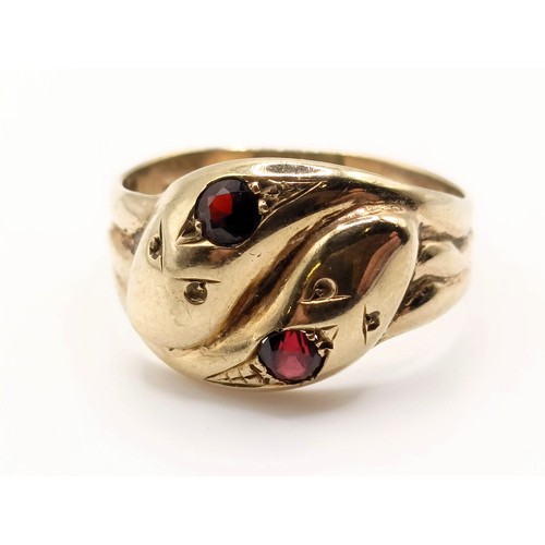 685 - A 9ct gold and garnet double snake ring, ring size V