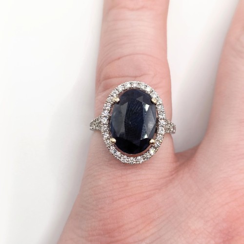 676 - An 18ct white gold, diamond and sapphire oval cluster ring, ring size M, sapphire 6.1ct approx., dia... 