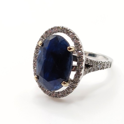 676 - An 18ct white gold, diamond and sapphire oval cluster ring, ring size M, sapphire 6.1ct approx., dia... 