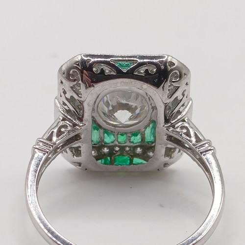 686 - An Art Deco style diamond and emerald target ring, central diamond 1ct approx., ring size N