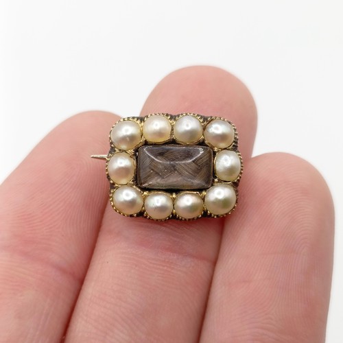 704 - A 19th century yellow coloured metal and cultured pearl memorial brooch, dated 1835