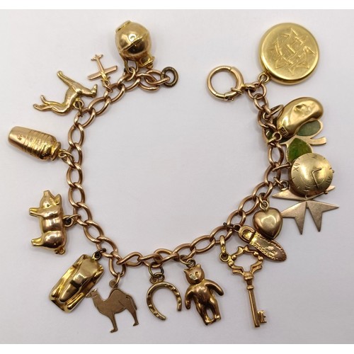 819 - A 9ct gold bracelet, with assorted 9ct and yellow metal charms, 27.7 g all in