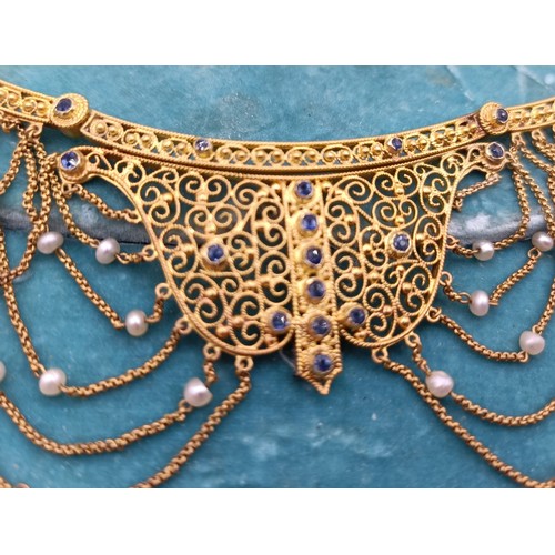 831 - A late 19th/early 20th century Renaissance style yellow metal, sapphire and seed pearl filigree neck... 