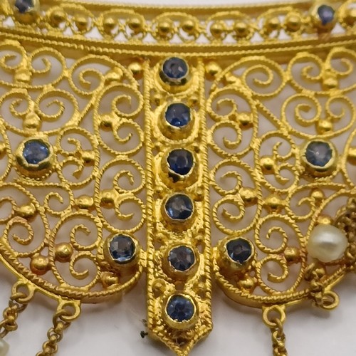 831 - A late 19th/early 20th century Renaissance style yellow metal, sapphire and seed pearl filigree neck... 