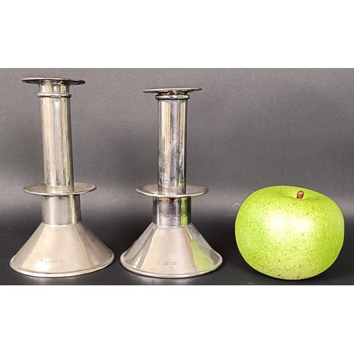 6 - A pair of George V silver candlesticks, on conical bases, London 1917, filled, 14 cm high (2)