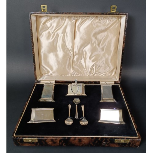29 - A George V silver five piece Art Deco cruet, comprising two pepper pots, two triangular salts, and a... 