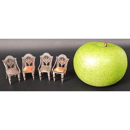 42 - A set of four silver coloured metal Continental miniature armchairs, with silk padded seats