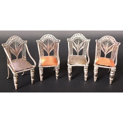 42 - A set of four silver coloured metal Continental miniature armchairs, with silk padded seats