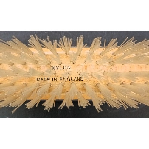 10 - A silver backed hand mirror, a pair of matching brushes and a silver mounted and bakelite lid, 12 cm... 