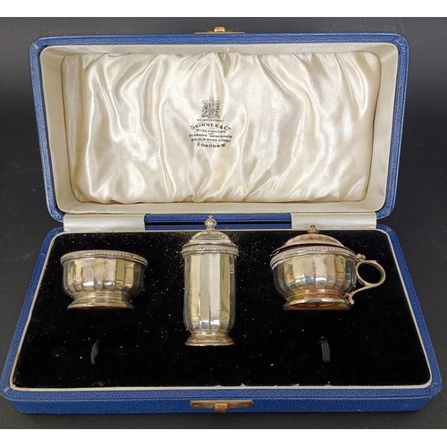 13 - A George VI silver three piece cruet, with blue glass liners, 2.7 ozt, cased
