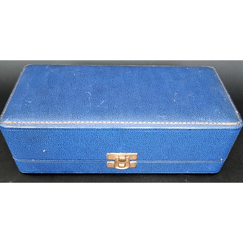 13 - A George VI silver three piece cruet, with blue glass liners, 2.7 ozt, cased