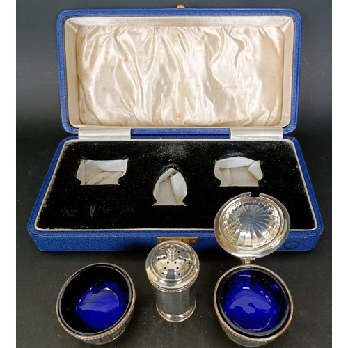 14 - A George VI silver three piece cruet, with blue glass liners, 2.7 ozt, cased
