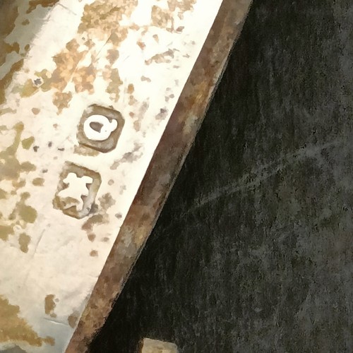 19 - A George V silver four division toast rack, 8 cm wide, a pair of silver pin dishes, and a vesta case... 