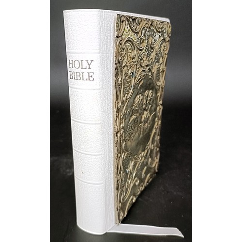 20 - A modern Holy Bible, the front cover with a silver panel embossed cherubs
