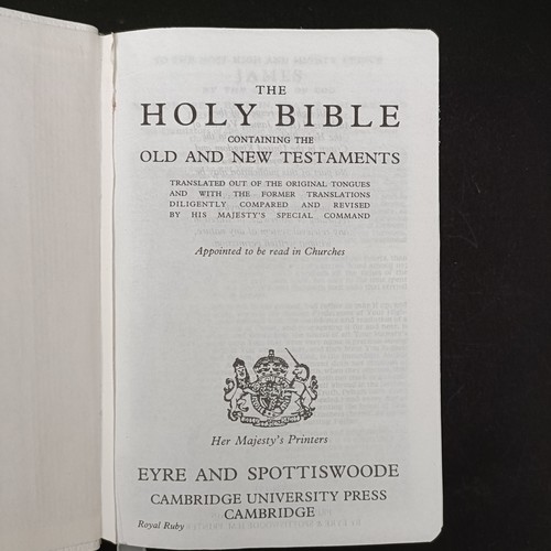 20 - A modern Holy Bible, the front cover with a silver panel embossed cherubs