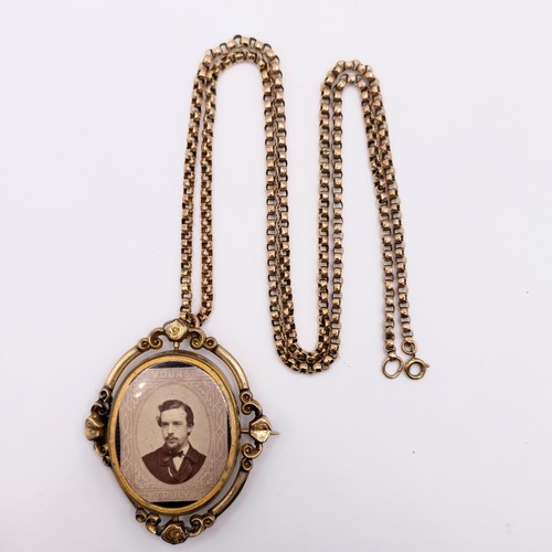 438 - A 19th century 9ct gold memorial locket, with a 19th century yellow coloured metal guard chai testin... 