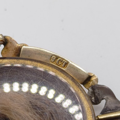 438 - A 19th century 9ct gold memorial locket, with a 19th century yellow coloured metal guard chai testin... 