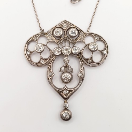 439 - An Art Nouveau style pendant with diamonds in a pierced setting, on a later/associated chain