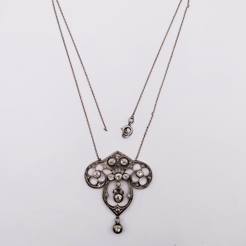 439 - An Art Nouveau style pendant with diamonds in a pierced setting, on a later/associated chain