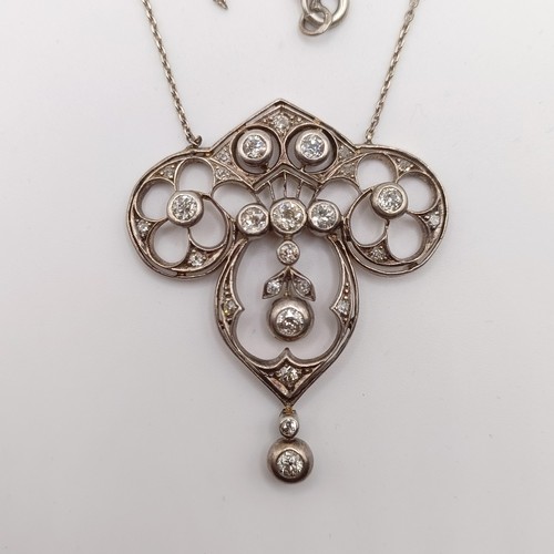 439 - An Art Nouveau style pendant with diamonds in a pierced setting, on a later/associated chain