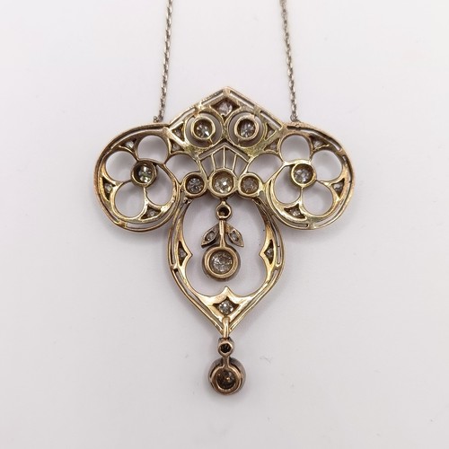 439 - An Art Nouveau style pendant with diamonds in a pierced setting, on a later/associated chain