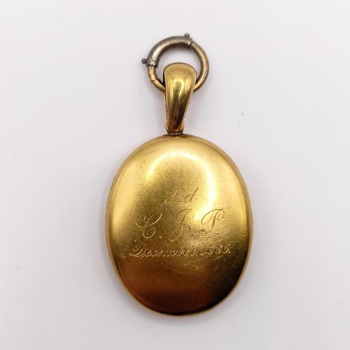 444 - A late 19th century yellow coloured metal oval locket, initialled L